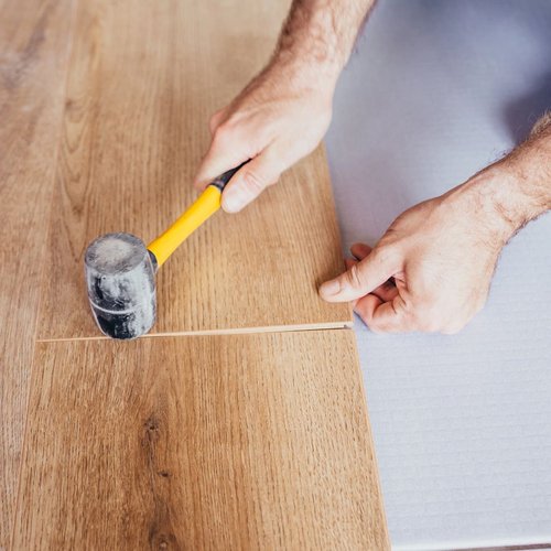 Man installing wood floor - Dream Home Interiors in Colorado Springs, CO